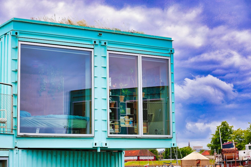 Casa container turquesa con ventanales